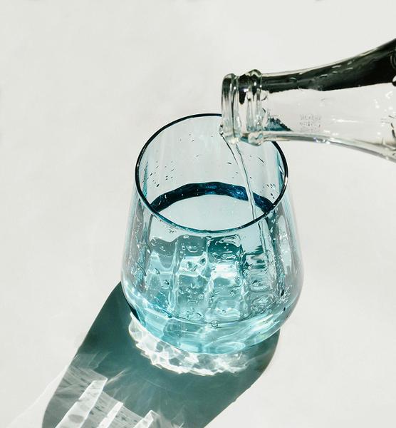 Pouring water from a bottle into a glass