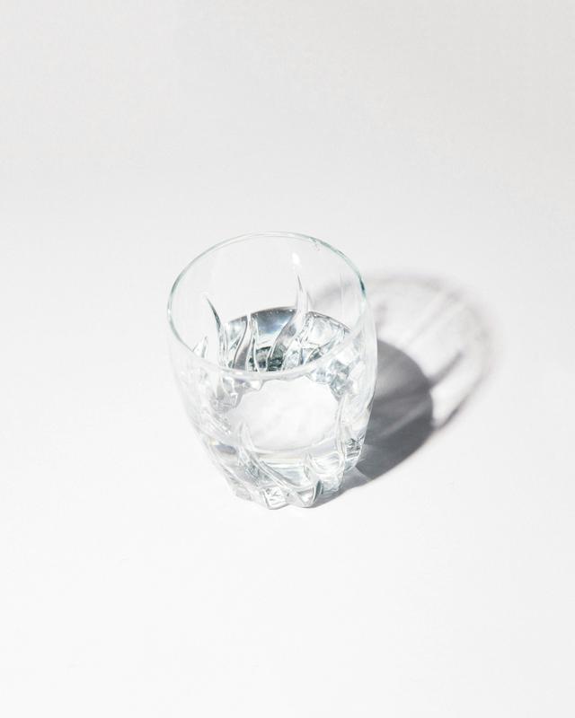 Hands holding glass of water